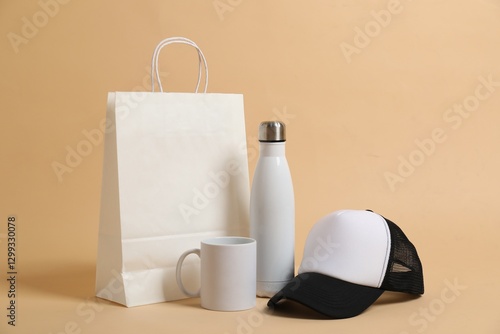Different blank items for branding on beige background. Mockup for design