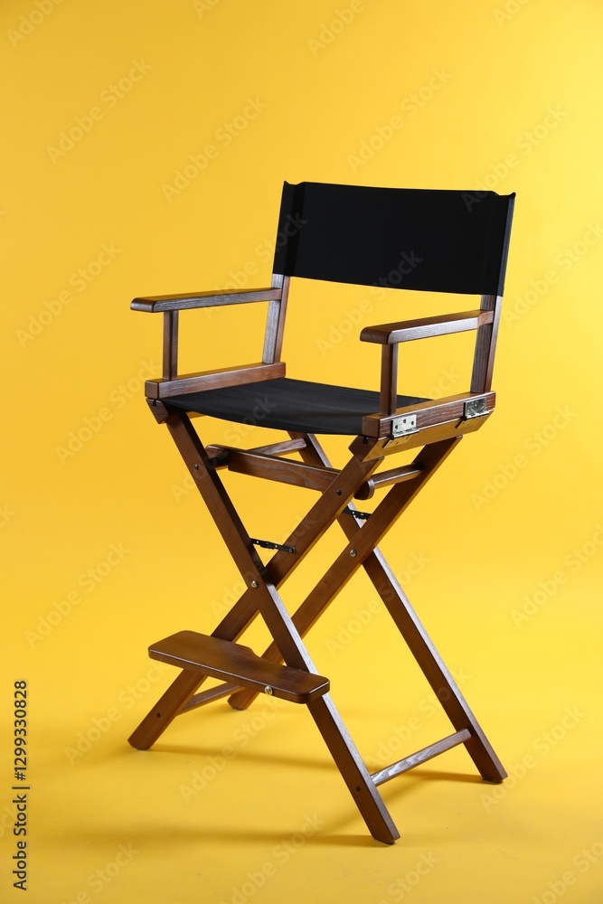 One empty director's chair on yellow background One empty director's chair on yellow background