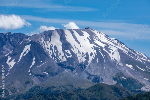 Majestic snow-capped mountain peak under a clear blue sky. Nature's grandeur.  Mount St. Helens National Volcanic Monument, Washington, USA