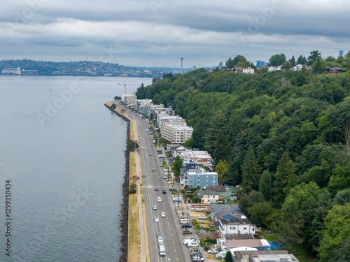 Aerial view of Alki waterfront, showing residential buildings lining the shoreline. Cars are visible on the road, and construction is underway. Seattle, Washington, USA photo