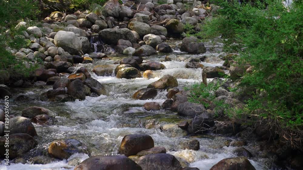 Streams of crystal clear water fall into the river creating splashes and bubbles, slow motion Streams of crystal clear water fall into the river creating splashes and bubbles, slow motion