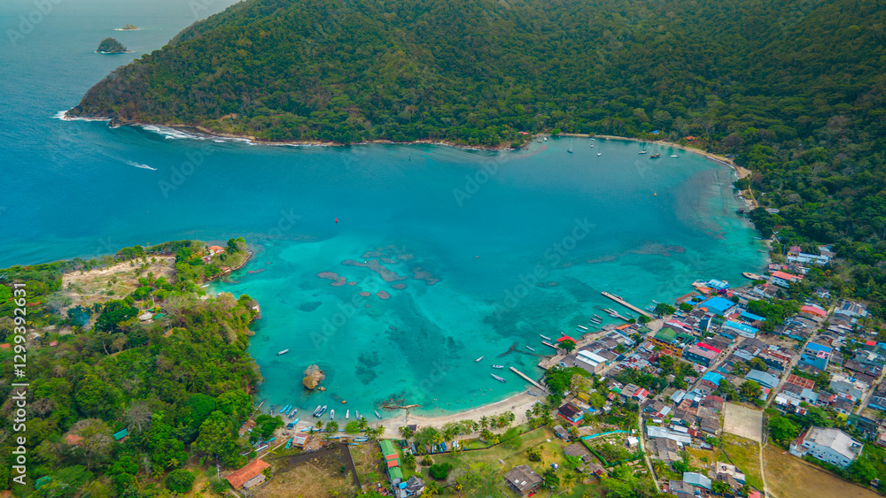 Fototapeta premium Aerial View of the Stunning Bay of Sapzurro, Choco, Colombia with Vibrant Waters and Cozy Coastal Village