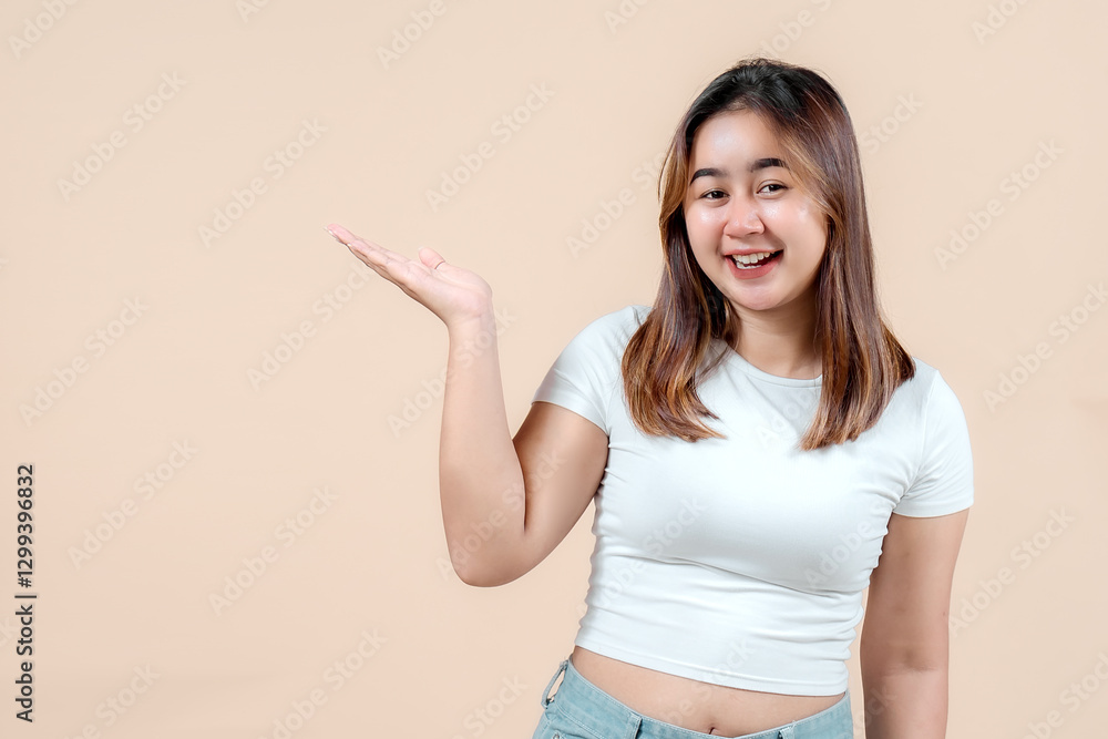 A cheerful young woman smiling and playfully pointing to her left while holding her hand out, set against a soft beige background, radiating joy and friendliness. A cheerful young woman smiling and playfully pointing to her left while holding her hand out, set against a soft beige background, radiating joy and friendliness.