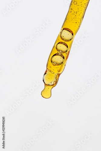 Macro shooting of pipette with yellow serum with vitamin C