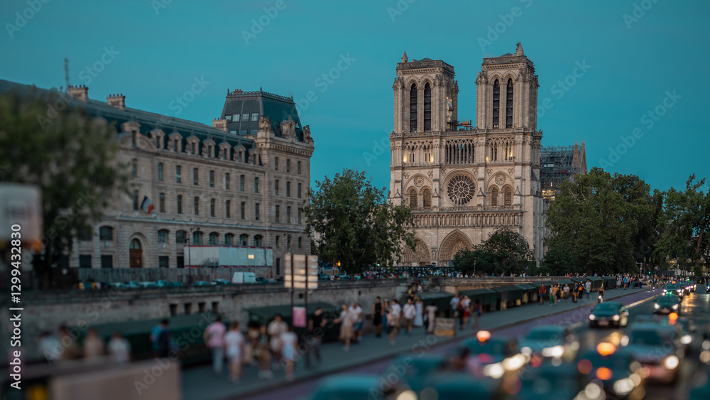 Beautiful evening scene around notre dame church in paris. Seen cars and tourists walking around and dusk settling down over this beautiful church