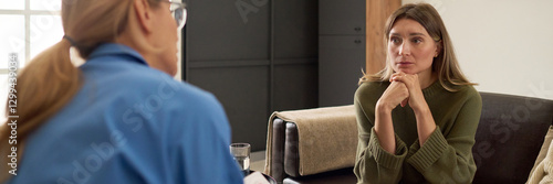 Canvas Print Header image of concerned mother speaking with therapist while sitting on couch