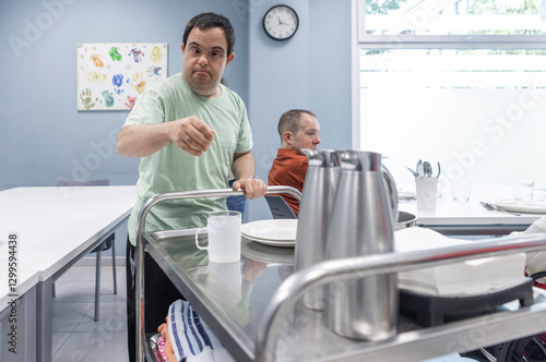 Man with Down Syndrome Helping Set the Table in a Day Center photo