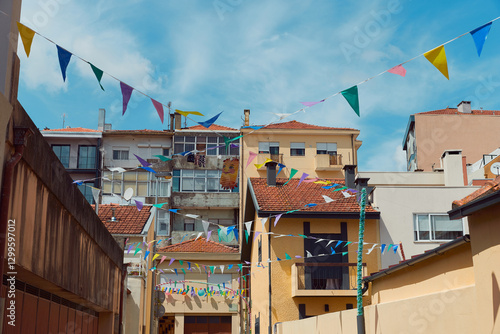 Festive bunting and lanterns decorate a narrow street for summer festival in June San Juan