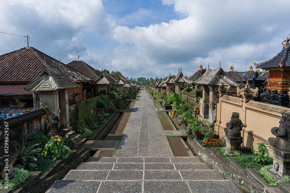 Fototapeta premium The oldest traditional village in Bali, Penglipuran in Bangli Regency. Calm and comfortable vibe, isolated by cloudy blue sky. As background or travel wallpaper