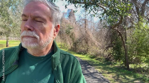 elderly man walking in a park close view