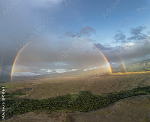 Rainbow during the rain in the entire Kurai steppe with a view of the snowy mountains. Rainbow over the Kurai ripples. A beautiful natural phenomenon during the rain. photo