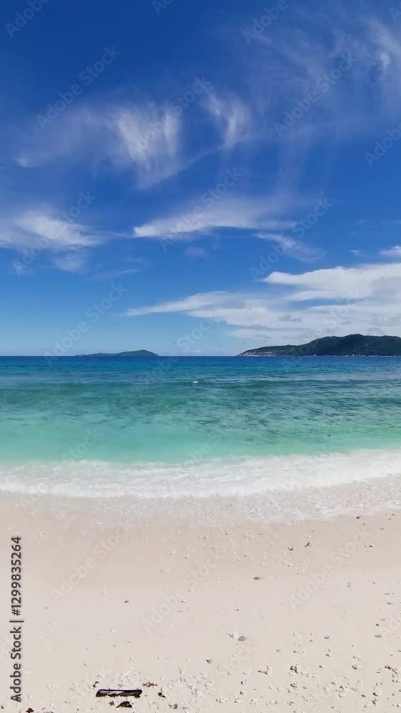 Secluded beach with fine white sand, tropical vegetation, and turquoise water with distant islands. Seychelles, La Digue. Secluded beach with fine white sand, tropical vegetation, and turquoise water with distant islands. Seychelles, La Digue.