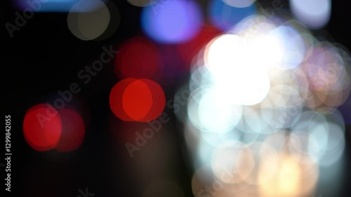 Night road lights blurred bokeh of cars in traffic on the road at night. Abstract bright blurred colored bokeh. Bokeh lights in the city night background