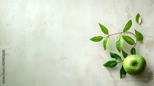 Fresh green apple with leaves on a textured light background, ideal for healthy lifestyle themes