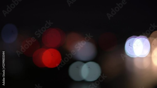 Night road lights blurred bokeh of cars in traffic on the road at night. Abstract bright blurred colored bokeh. Bokeh lights in the city night background