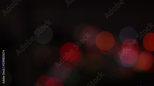 Night road lights blurred bokeh of cars in traffic on the road at night. Abstract bright blurred colored bokeh. Bokeh lights in the city night background