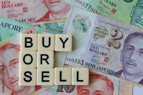 Buy or sell signage with a background of Singaporean dollars.