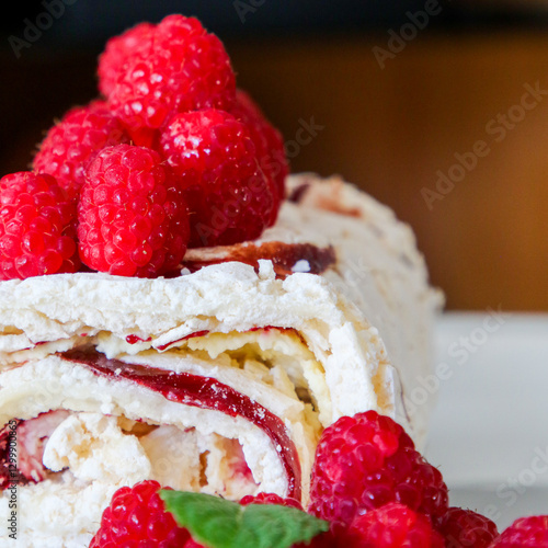 Marbled roulade or Swiss roll with raspberries.