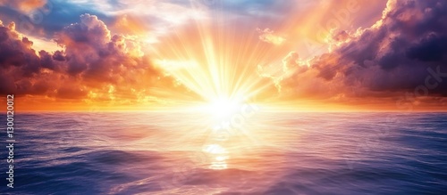 Vibrant sunset over the calm ocean with brilliant beams of light rising amidst colorful clouds creating a stunning uplifting horizon scene