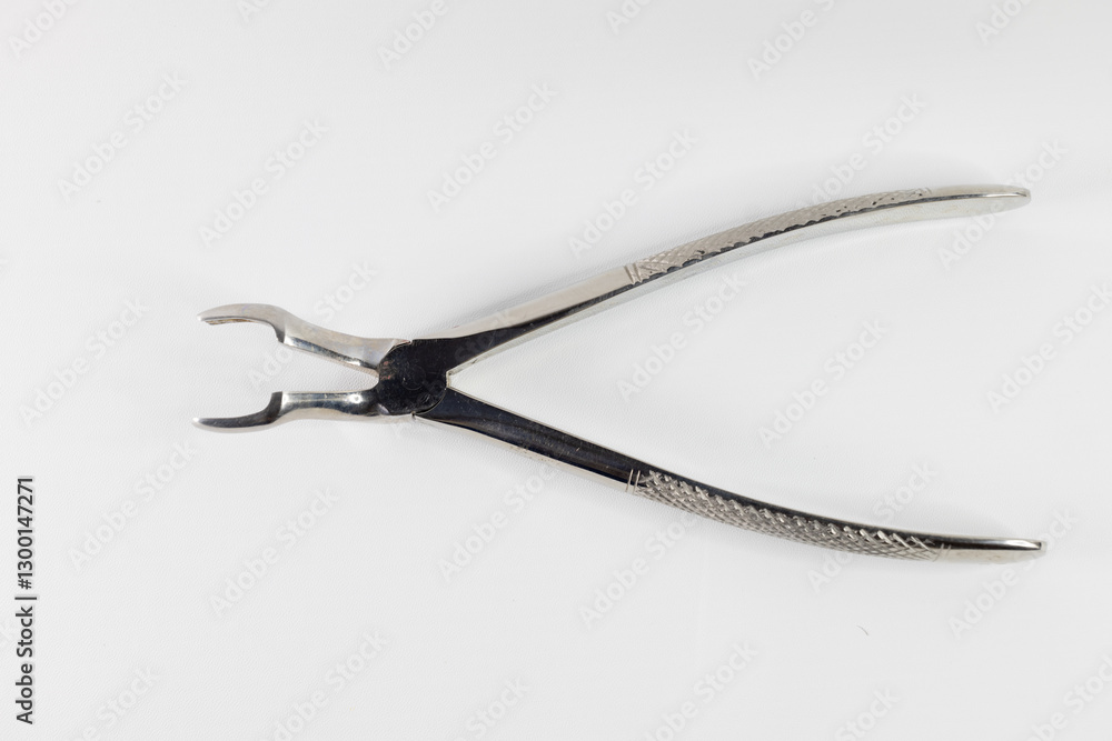 Stainless steel forceps for tooth extraction. The forceps in this photo are for extracting the upper molars, especially the rear ones. Photographed against a white background. Stainless steel forceps for tooth extraction. The forceps in this photo are for extracting the upper molars, especially the rear ones. Photographed against a white background.