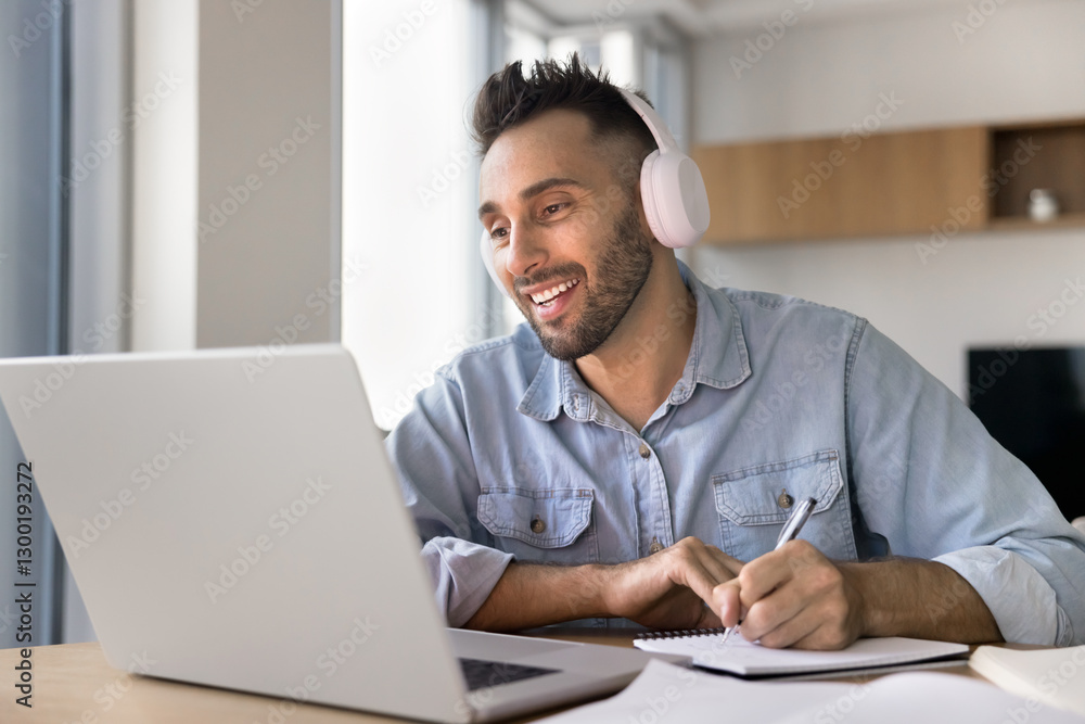 Smiling man studying online, wear wireless headphone engaged in webinar, gaining new professional knowledge, listening audio course, develop foreign languages skills. Education using modern technology Smiling man studying online, wear wireless headphone engaged in webinar, gaining new professional knowledge, listening audio course, develop foreign languages skills. Education using modern technology