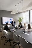 Boardroom presentation. Focused businesspeople group of diverse gender age gather by conference table on staff briefing training workshop listen to coach boss project manager speak on project progress