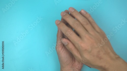 Footage video 4k. Hands holding purple or violet ribbon on blue. Pancreatic Cancer ,Testicular Cancer Awareness, Cancer Survivor, Leiomyosarcoma, World Cancer Day. Healthcare, insurance concept.