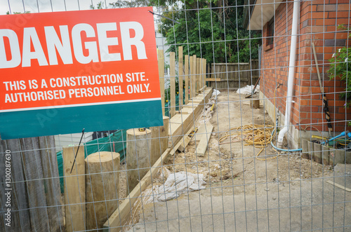 Obraz na płótnie Danger sign on metal protection fence. Construction site for residential retaining wall rebuild. Auckland. w salonie