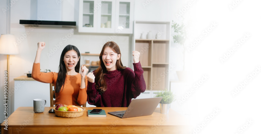 Teamwork and creativity with young adults collaborating on laptops and tablets in a cozy workspace.