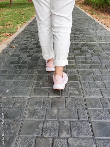 back view of woman with sneakers walking