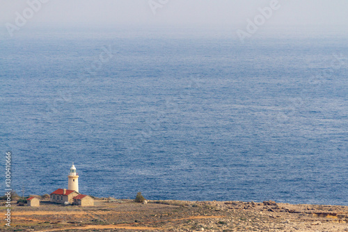 View from above of the lighthouse on the deserted rocky shore of Cape Greco on a sunny day. January. Mediterranean, Cyprus