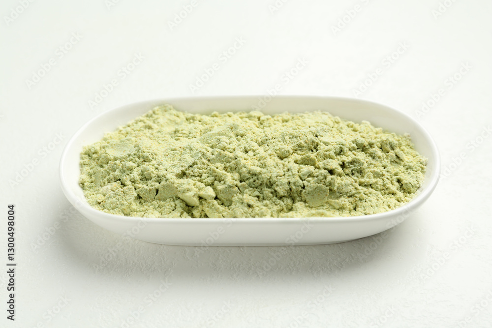 Dry wasabi powder on white textured table, closeup Dry wasabi powder on white textured table, closeup