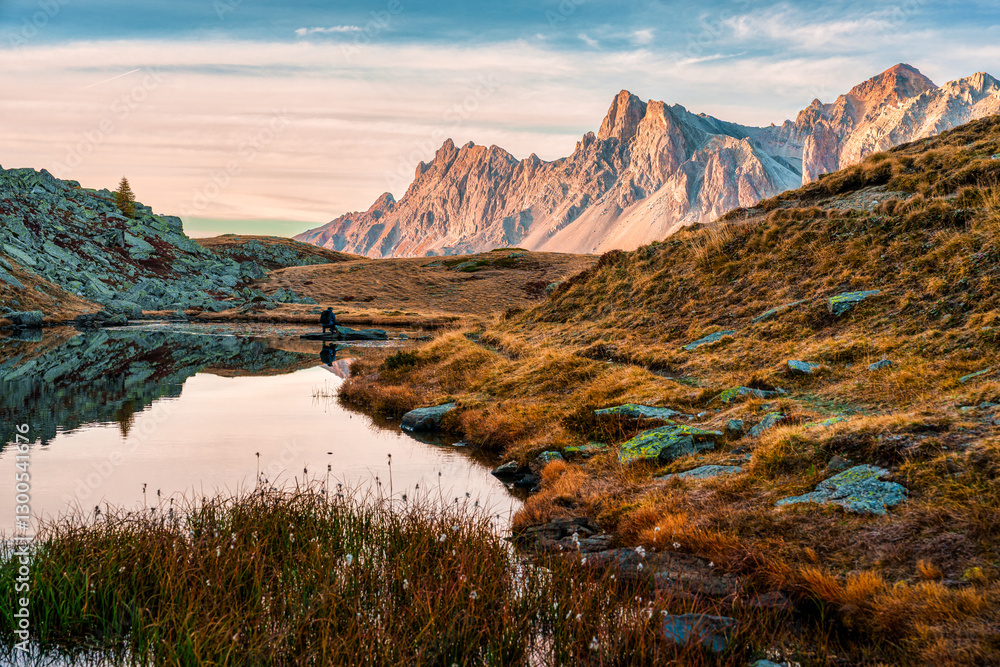 Fototapeta premium Sunrise over Massif des cerces reflect on Lac Long in Claree Valley at France