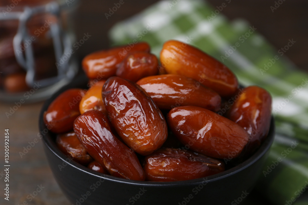 Tasty dried dates in bowl on table, closeup Tasty dried dates in bowl on table, closeup