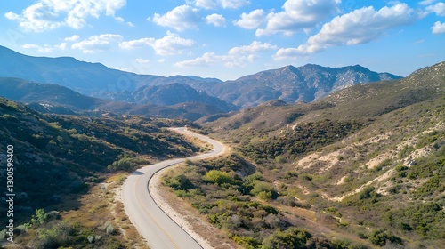 Winding road journey through majestic mountains scenic landscape aerial view nature exploration