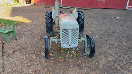 A captivating 4K video of an antique tractor being showcased in an open-air museum nestled in the picturesque landscapes of Norway.
