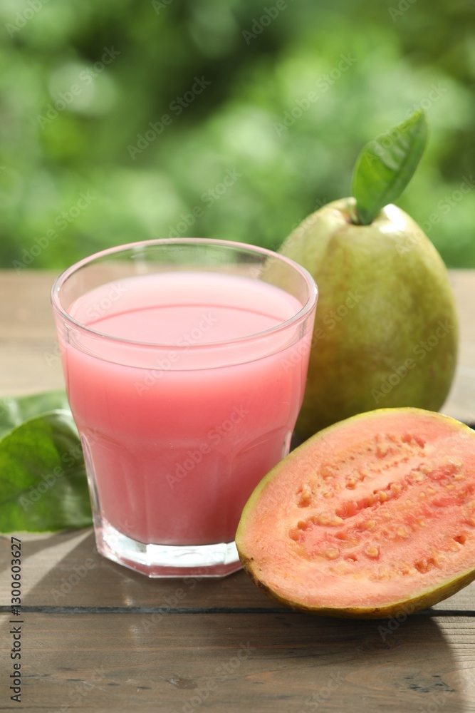 Refreshing guava juice and fresh fruits on wooden table, closeup Refreshing guava juice and fresh fruits on wooden table, closeup