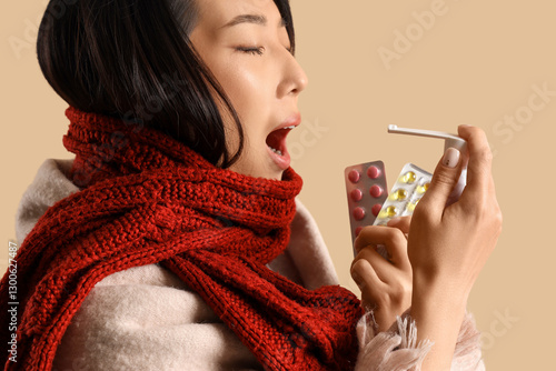 Ill Asian woman with pills ...