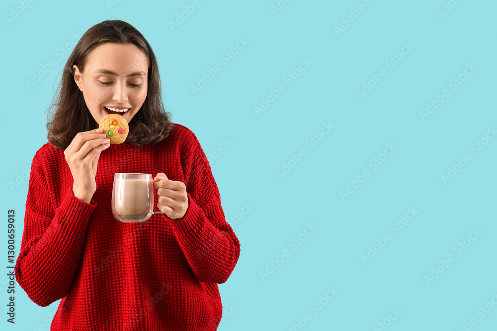 Beautiful young woman drinking coffee with cookie on blue background Beautiful young woman drinking coffee with cookie on blue background