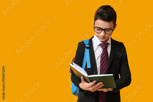 Schoolboy reading book on y...