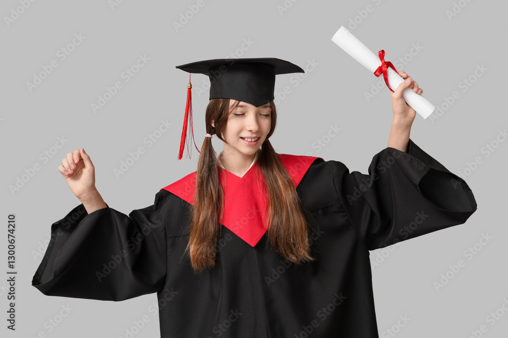 Schoolgirl in bachelor robe with diploma on grey background Schoolgirl in bachelor robe with diploma on grey background