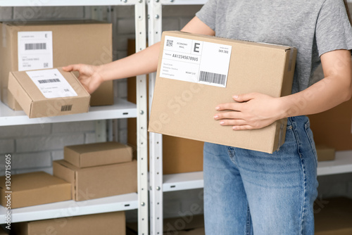 Woman with parcel boxes at ...