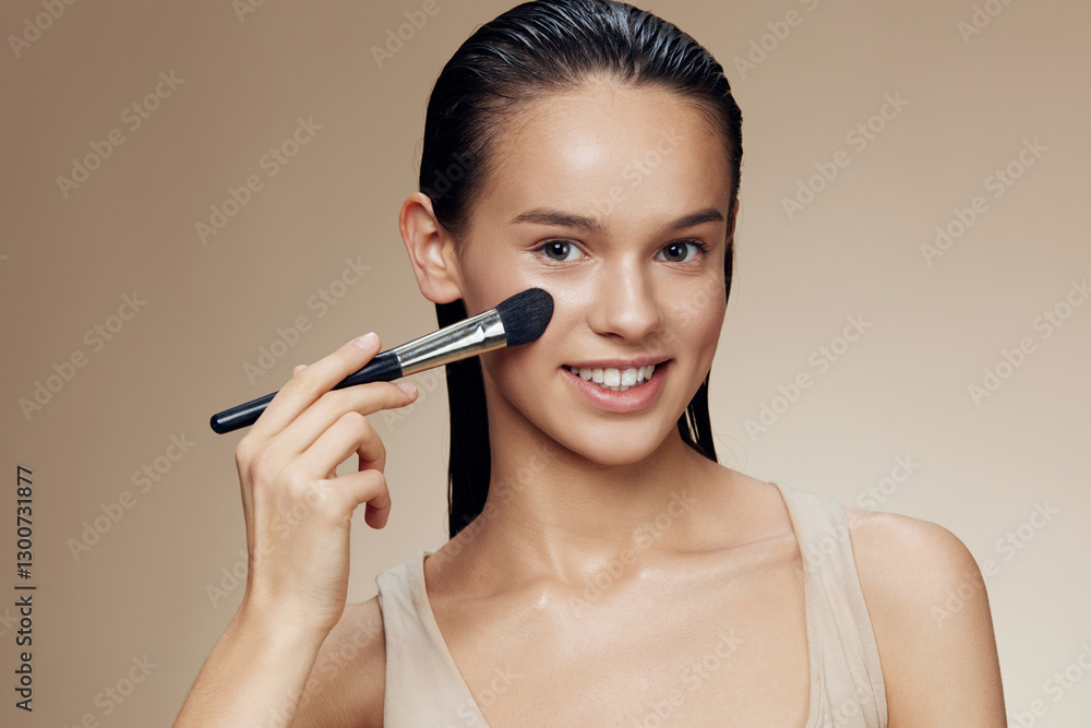 Young woman applying makeup with a brush, showcasing a radiant smile and natural beauty, perfect for beauty and skincare concepts Young woman applying makeup with a brush, showcasing a radiant smile and natural beauty, perfect for beauty and skincare concepts