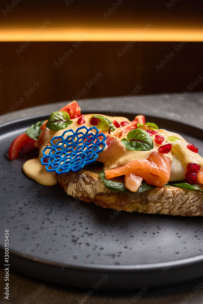 Gourmet open-faced salmon sandwich with vibrant toppings, ornate design on dark plate, stylish presentation food concept