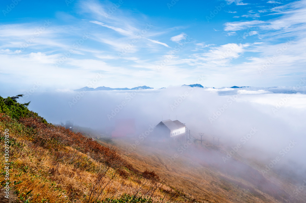 Hiking Route to Happo Pond and the Japanese Alps mountains landscape with mist background on Hakuba Happo One in Hakuba, Nagano, Japan