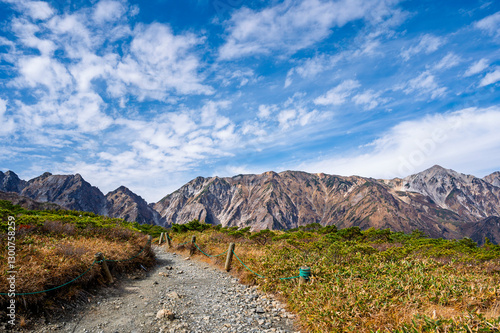 Hiking Route to Happo Pond and  the Japanese Alps mountains landscape with mist background on Hakuba Happo One in Hakuba, Nagano, Japan photo