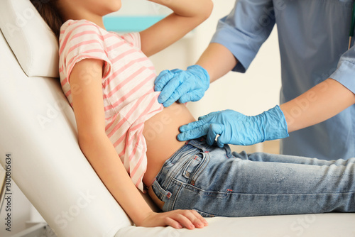 Female doctor examining tee...