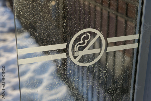 no smoking symbol on a glass surface outdoors