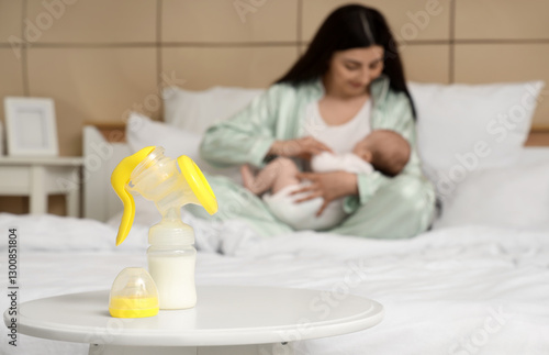 Breast pump with milk on ta...