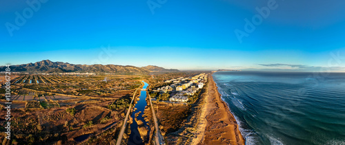 Obraz na płótnie Panorámica de la playa de Xeraco y su rio al amanecer. A vista de drone. w salonie
